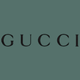 The image shows the word "GUCCI" in uppercase black letters centered on a muted green background.